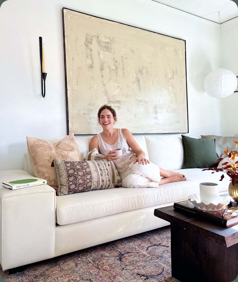 woman sitting on white blumen sectional