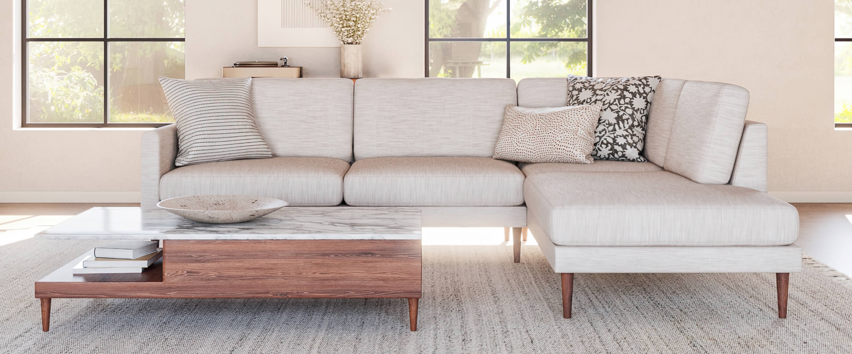 Beige Lala Bumper Sectional in white room with walnut coffee table