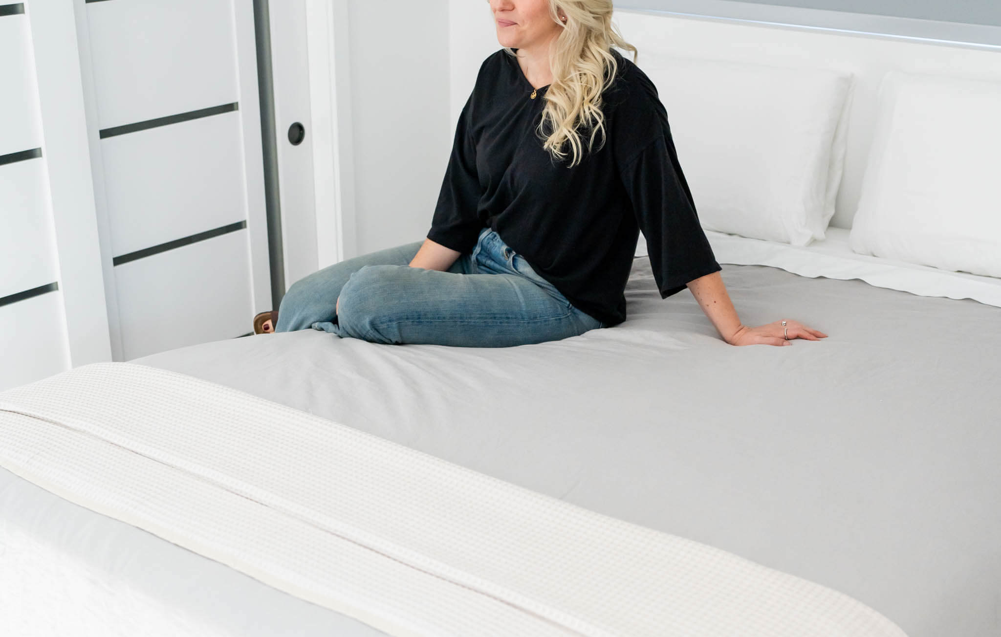 IRL: Woman sitting on Medley Organic Natural Latex Mattress