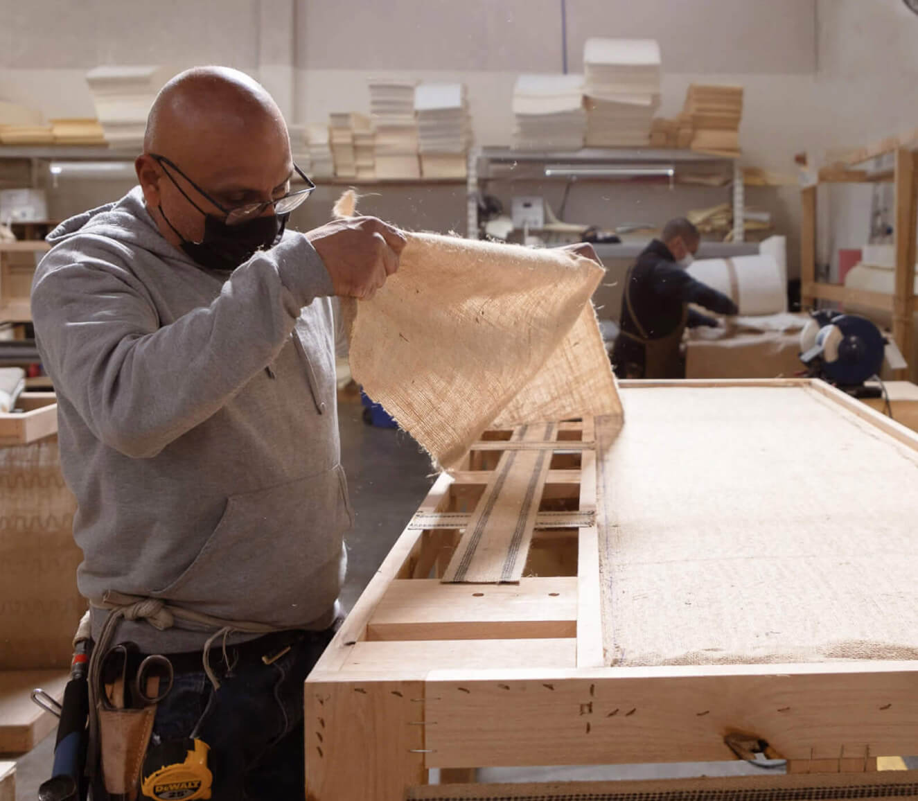 Medley worker applying jute to a frame