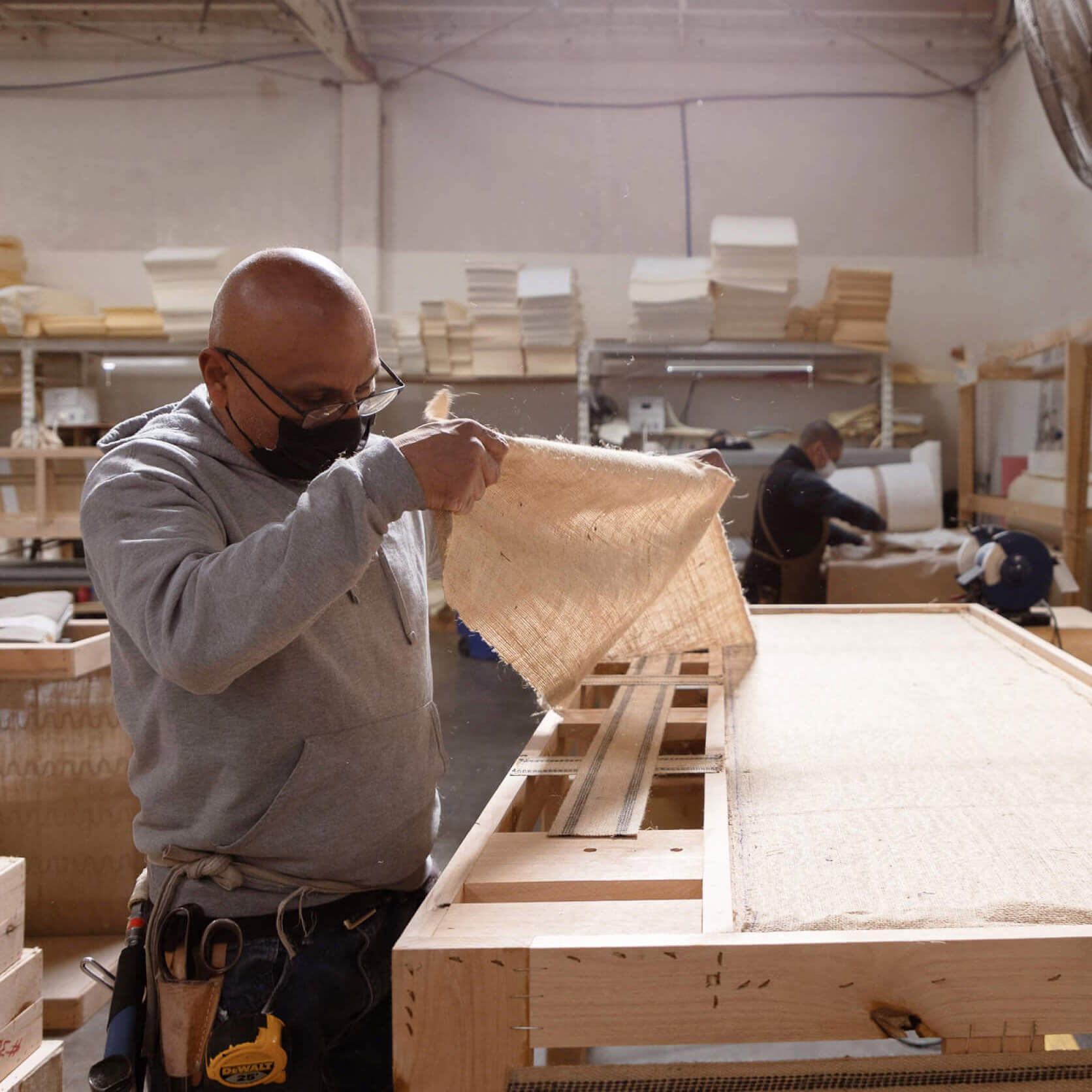 medley worker applying jute to frame