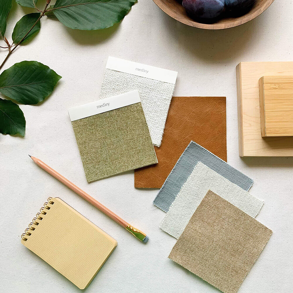 Medley fabric and wood swatches laid out on a table