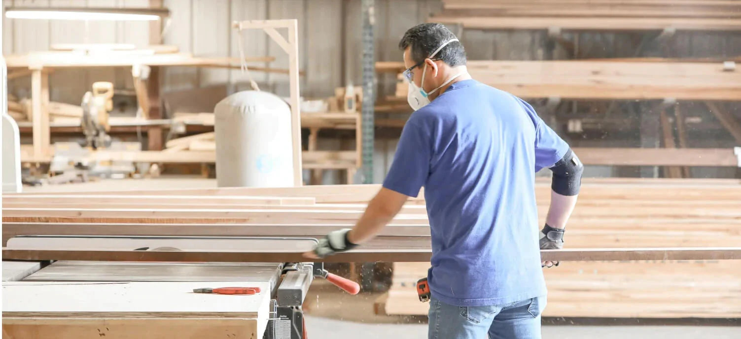 Woodworker in the shop trimming boards