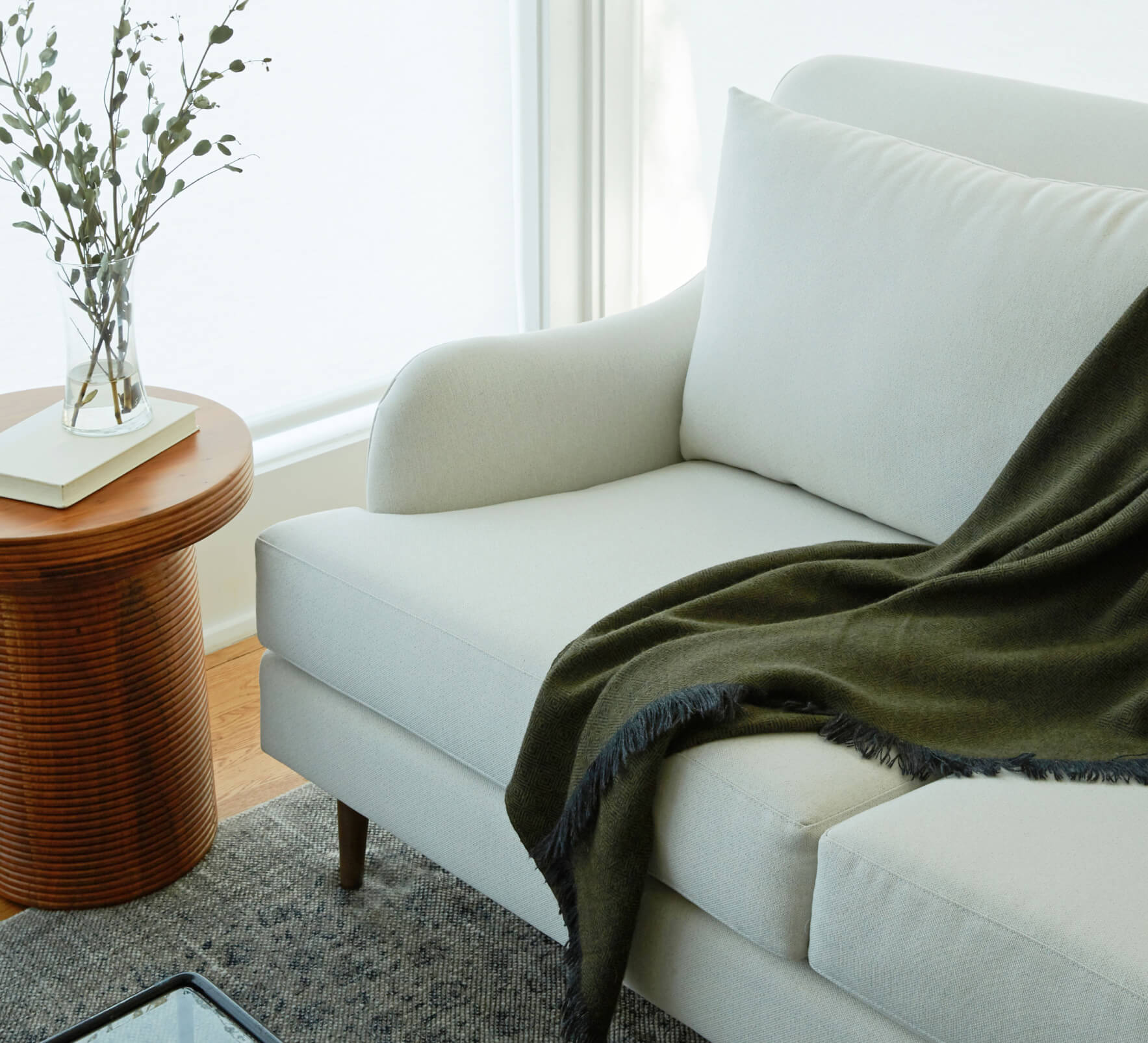 white kaydan sofa with green throw blanket