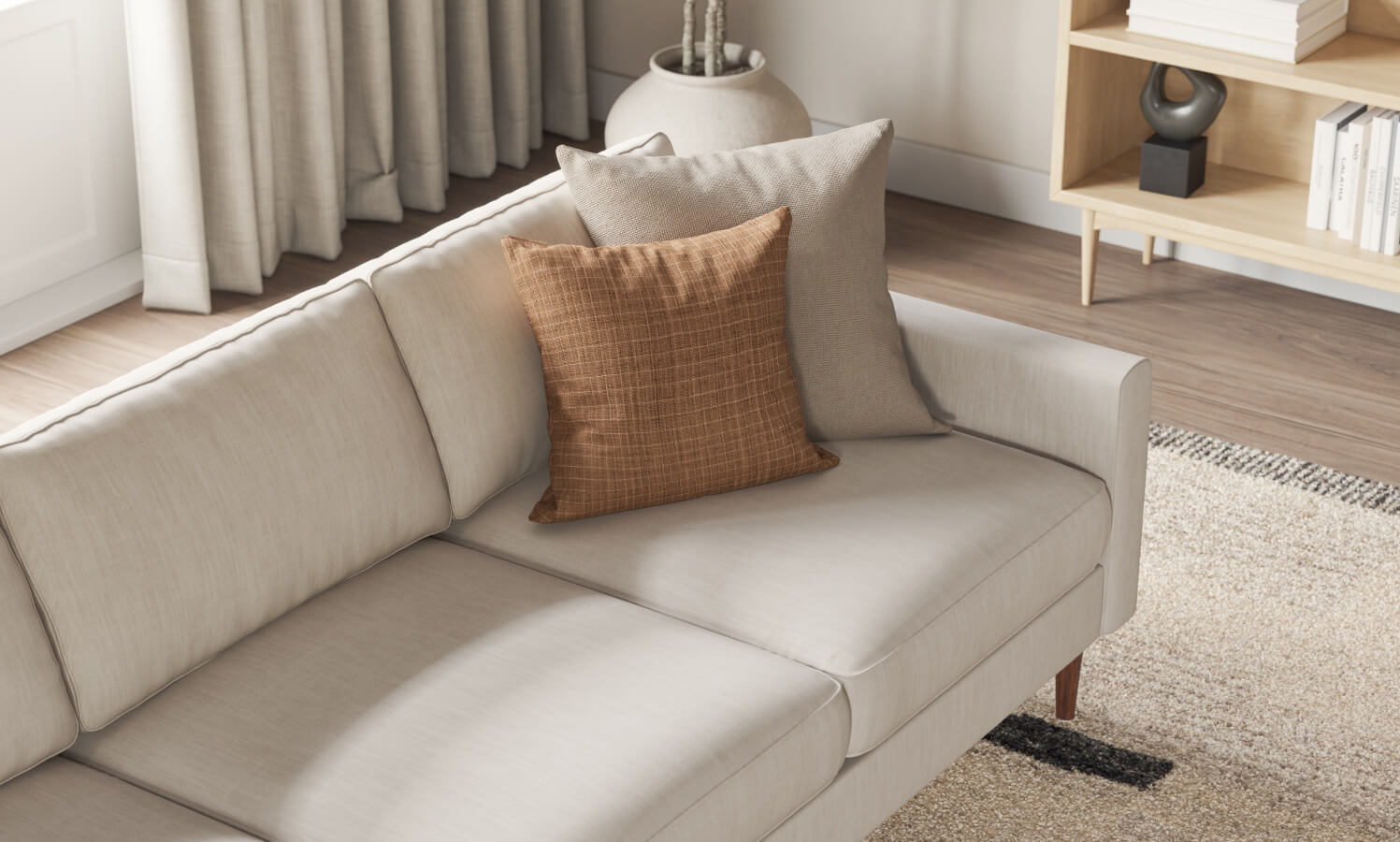 IRL: Lala sofa in beige fabric with orange pillow