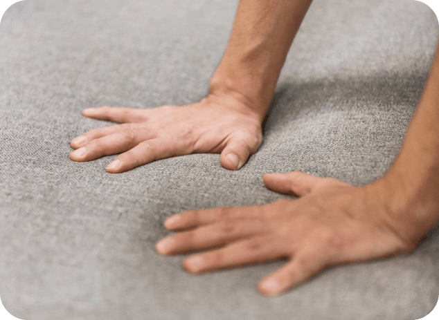 hands pressing on cushion