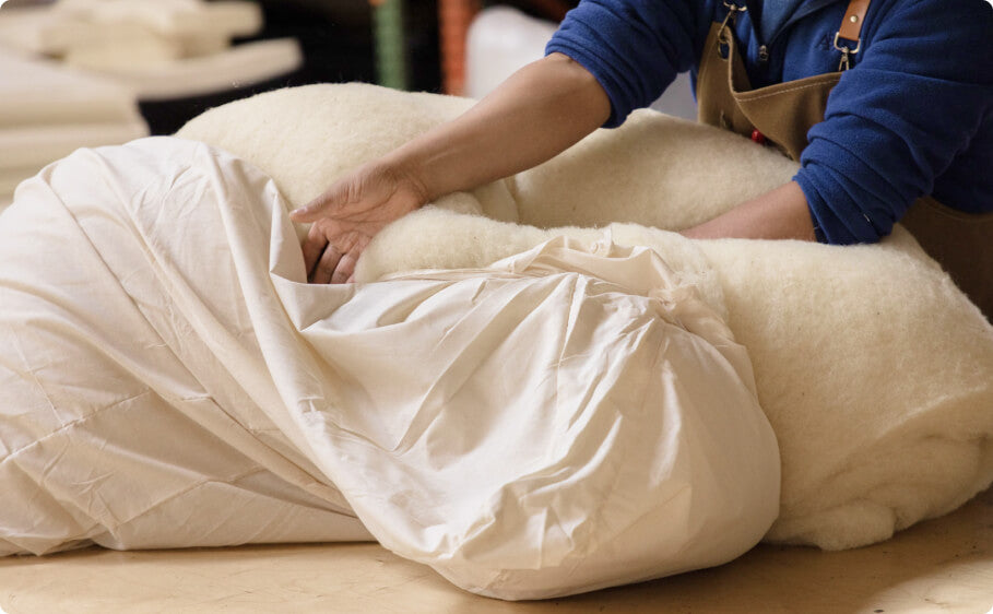 medley worker stuffing a cotton lining with wool