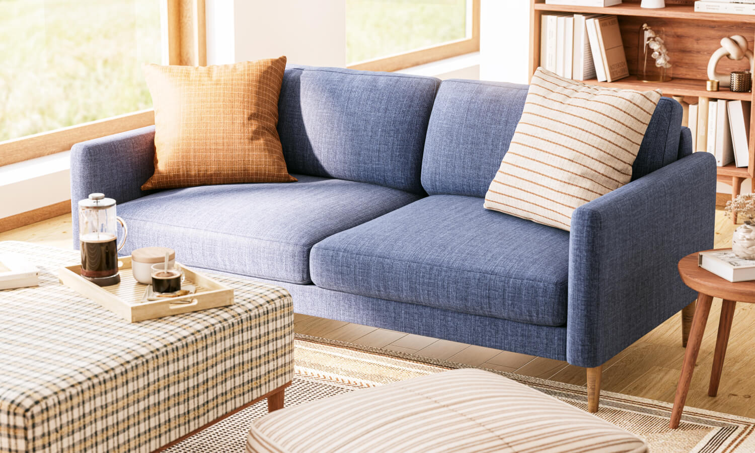 IRL: Shown in Smart Navy fabric with Voya Side Table, Burr Accent Chair in Smart Canyon fabric, Noah Ottoman in Arya, Anders Shelf, and Lulu Throw Pillows